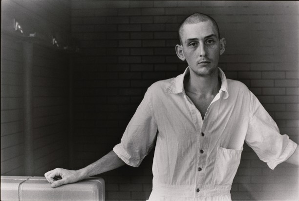 Untitled (Inmate with shaved head in white uniform)