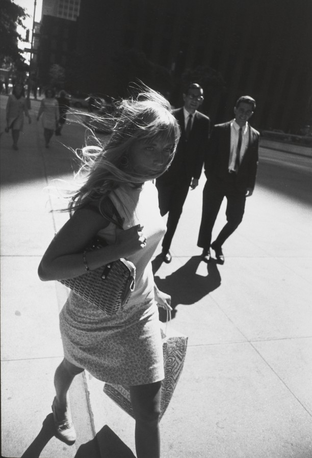 Untitled (Woman walking down street with her hair blowing behind her)